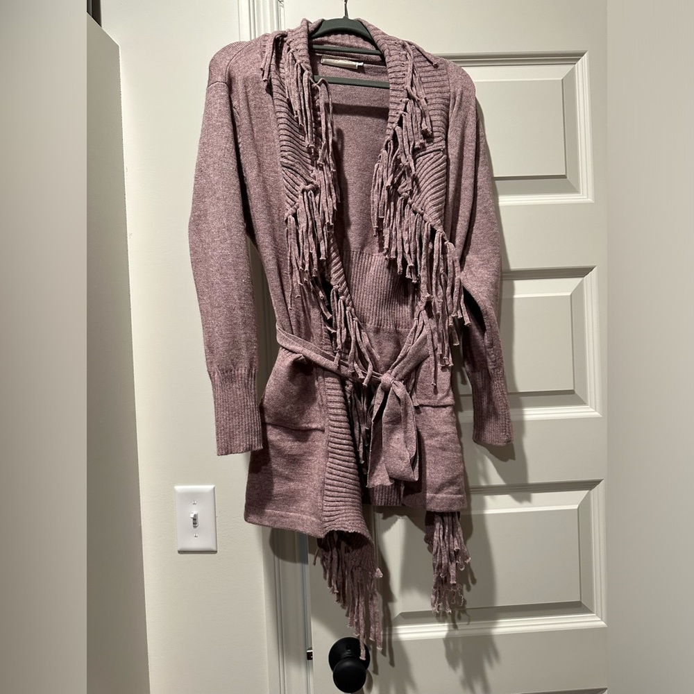 Dusty rose sweater with fringe.
